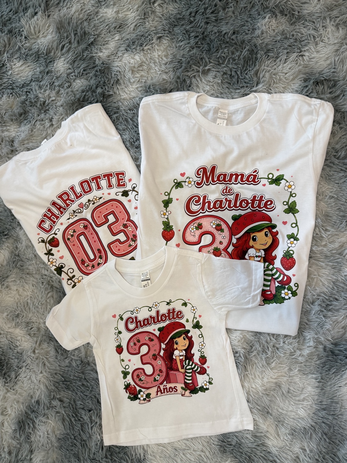 Matching Strawberry Shortcake birthday shirts customized for Charlotte and her family